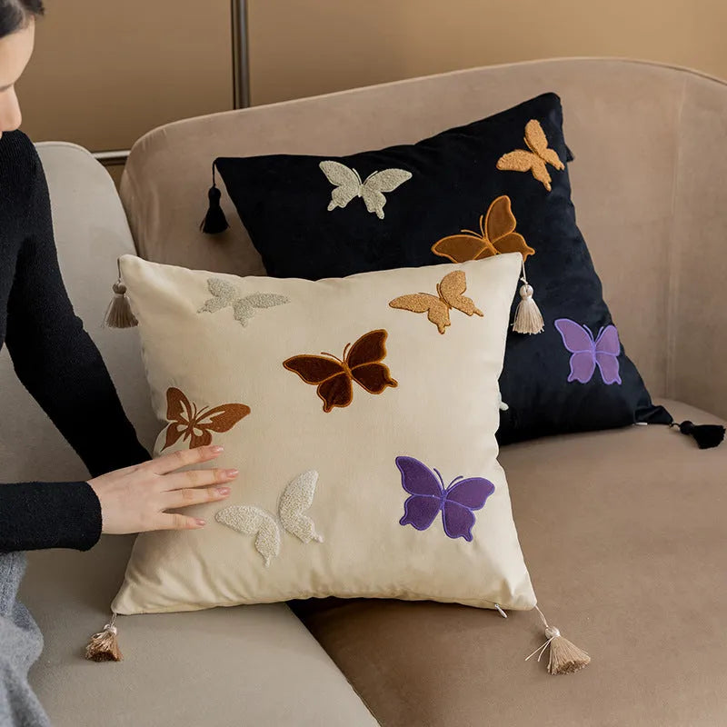Square beige cushion with detailed black butterfly embroidery in a Chinese style pattern.
