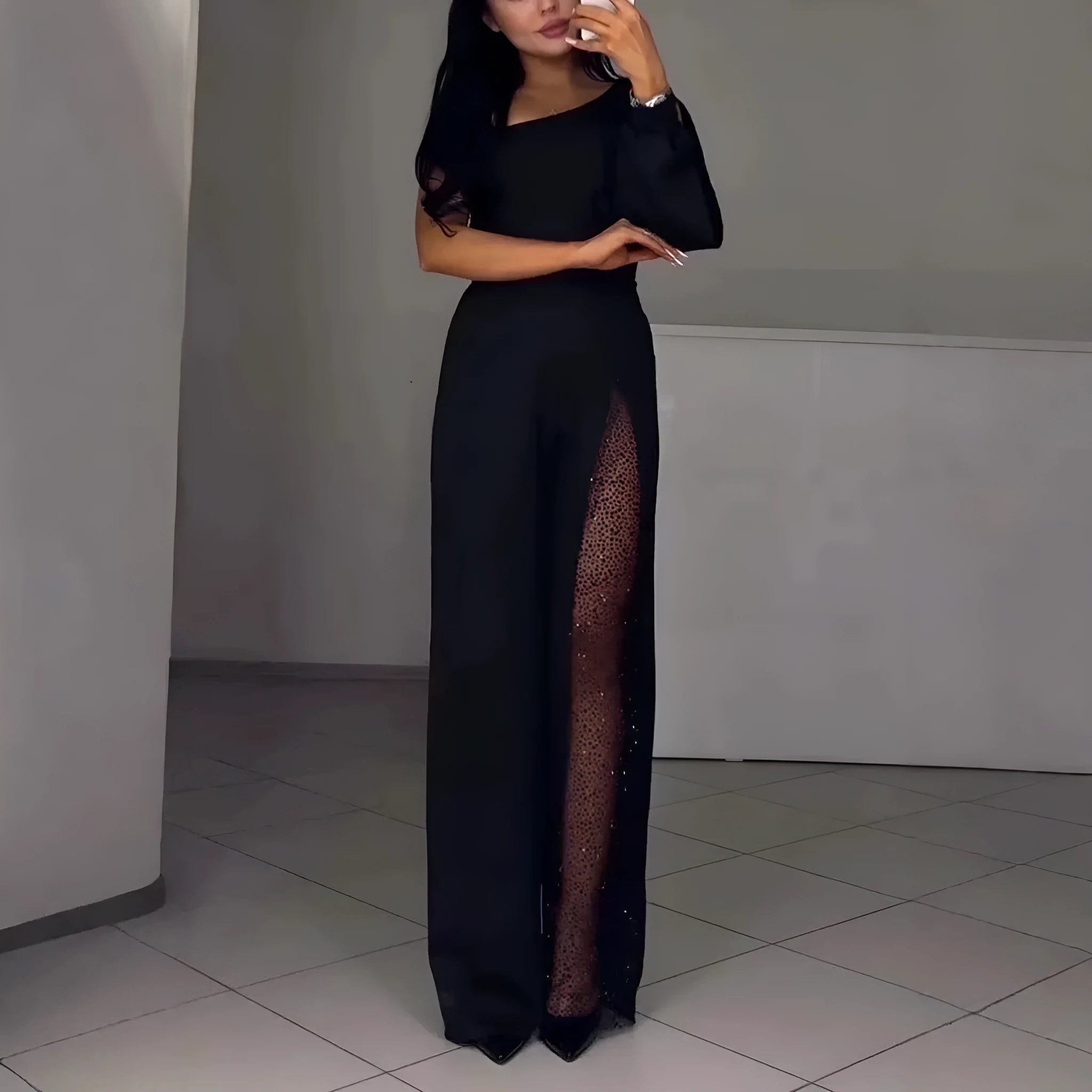 Women's black polyester jumpsuit with oblique shoulder neckline and high slit leg detailing