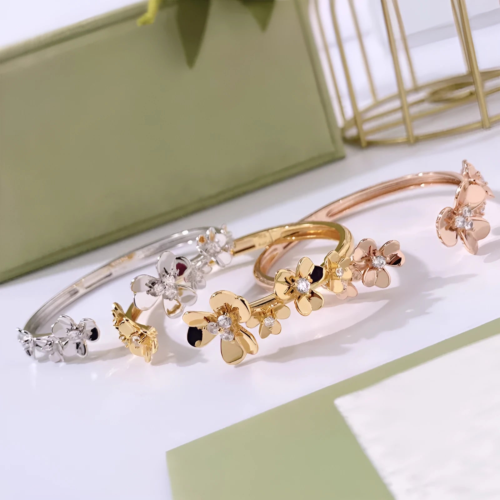Three-leaf flower micro inlaid zircon bracelet in gold, rose gold, and silver colours on a copper base with electroplated finish.