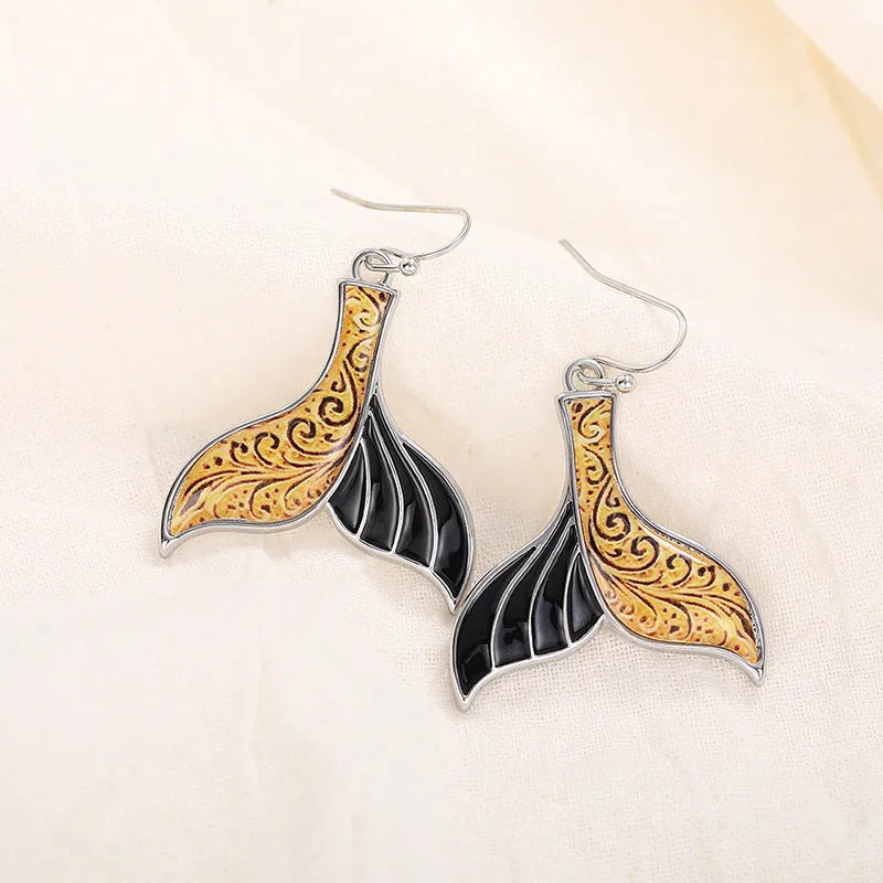 Women's white gold colour fishtail earrings with whale design