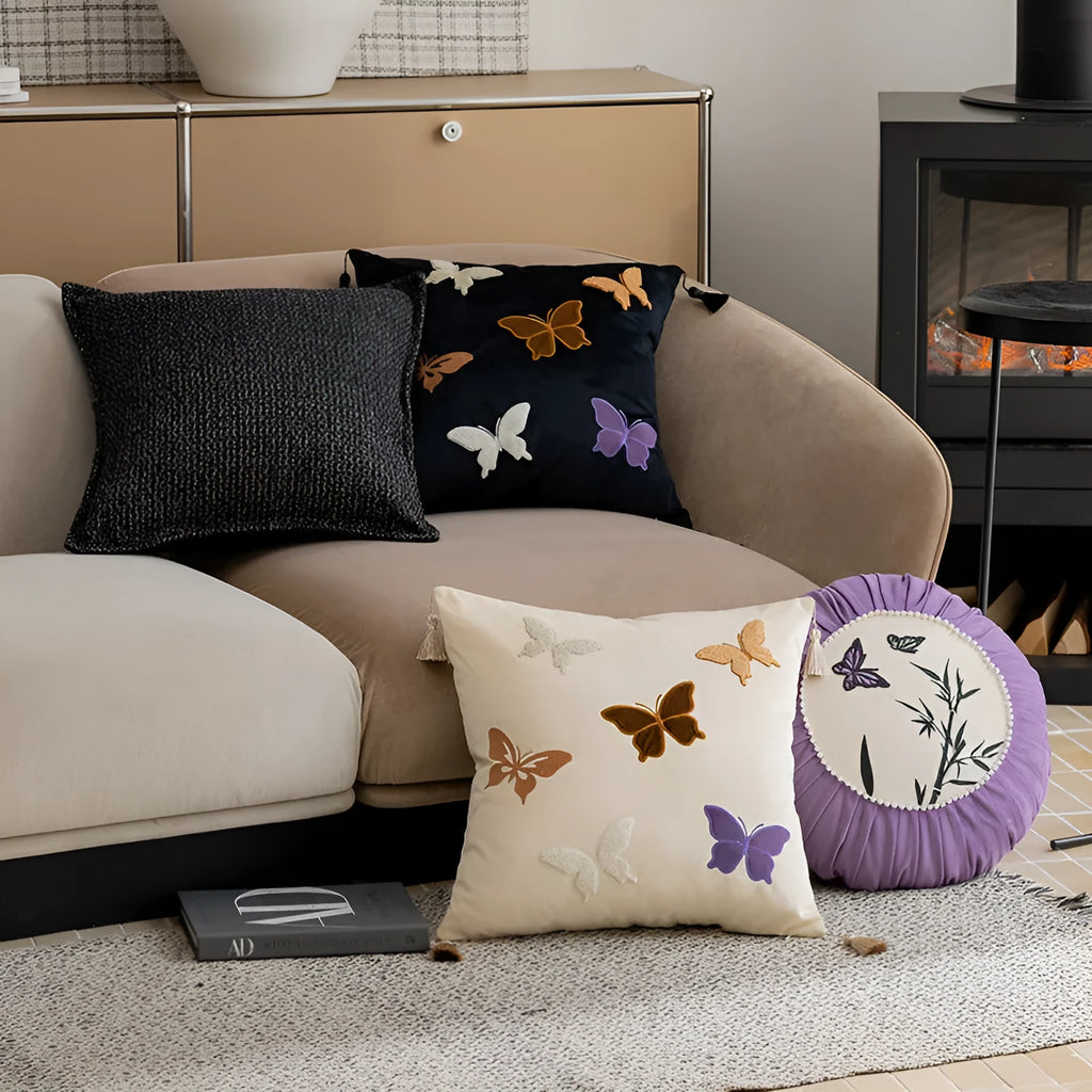 Square beige cushion with detailed black butterfly embroidery in a Chinese style pattern.