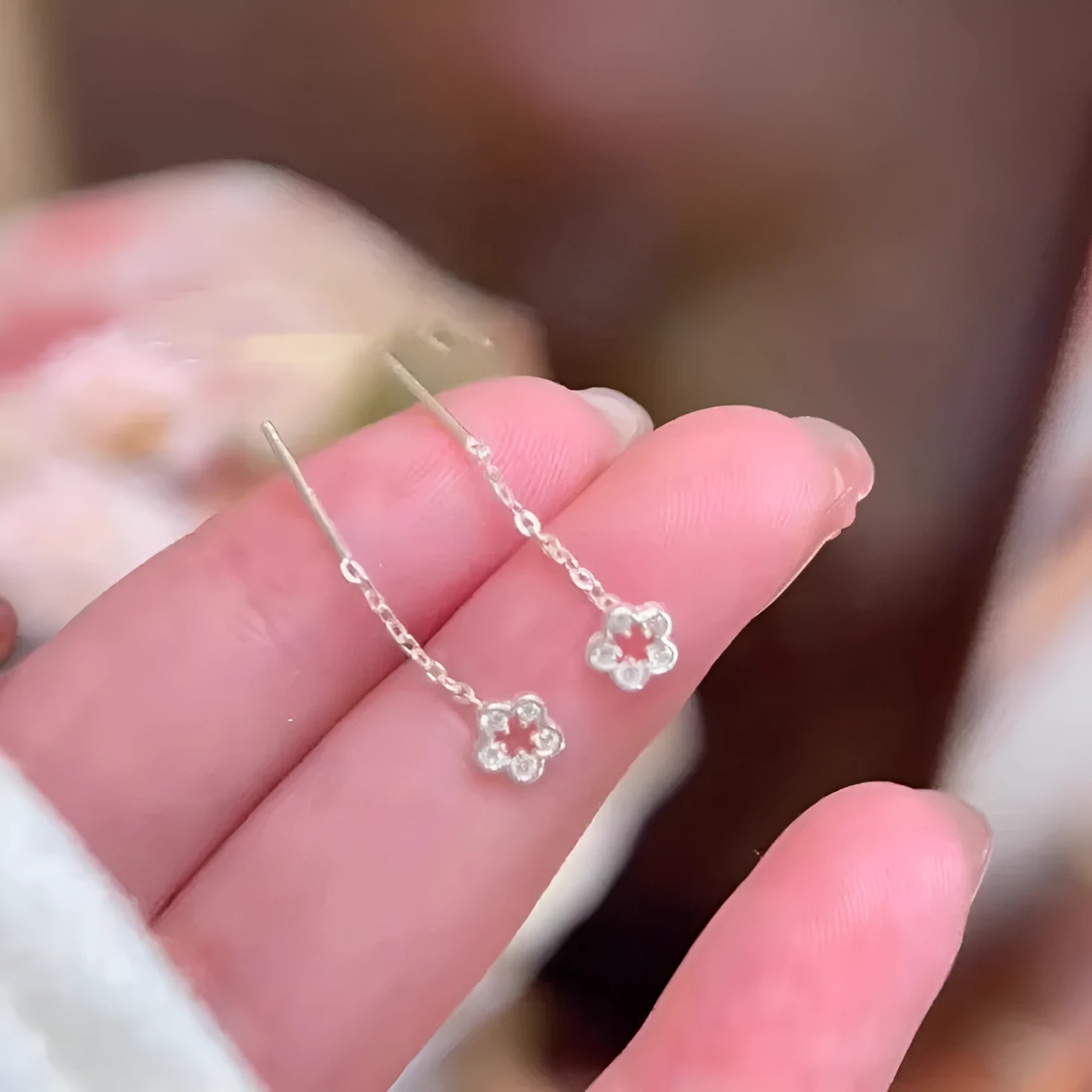 Sterling silver hollow flower hanging earrings with petal detailing and alloy construction