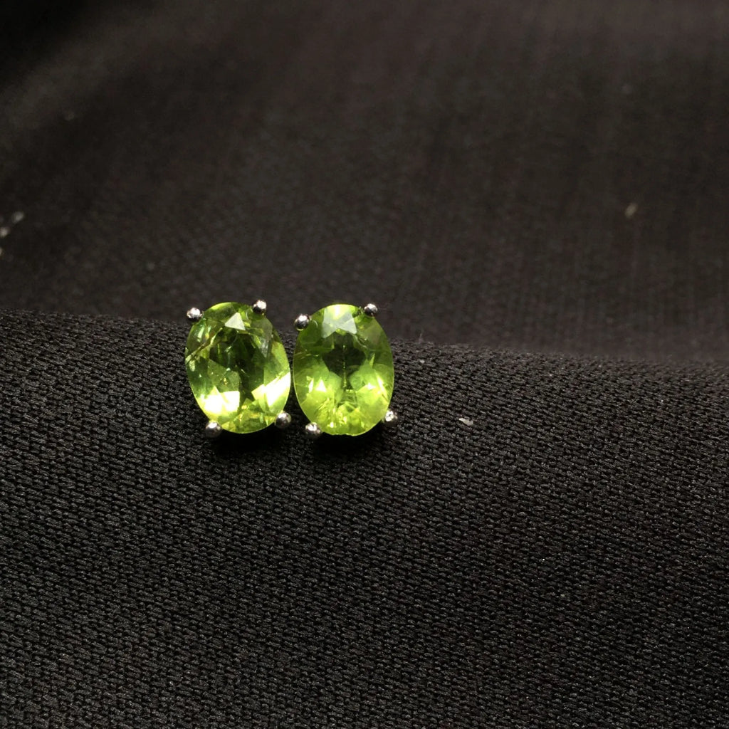 Natural olivine faceted stud earrings in S925 sterling silver with 6 × 8mm grass green oval stone