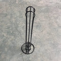Black wrought iron coffee capsule rack holding 20 pods on display shelves.