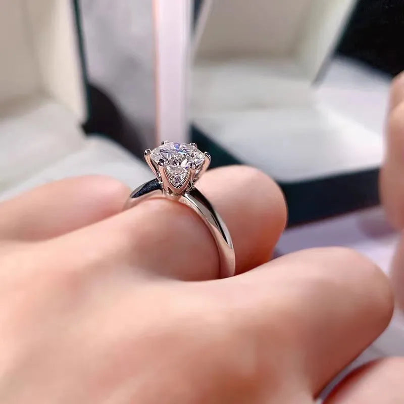 White gold plated copper ring with six-claw set zircon stone, geometric shape.