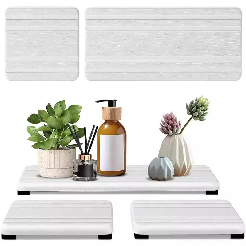 Three square diatom oil bathroom drying mats in solid colour on a countertop