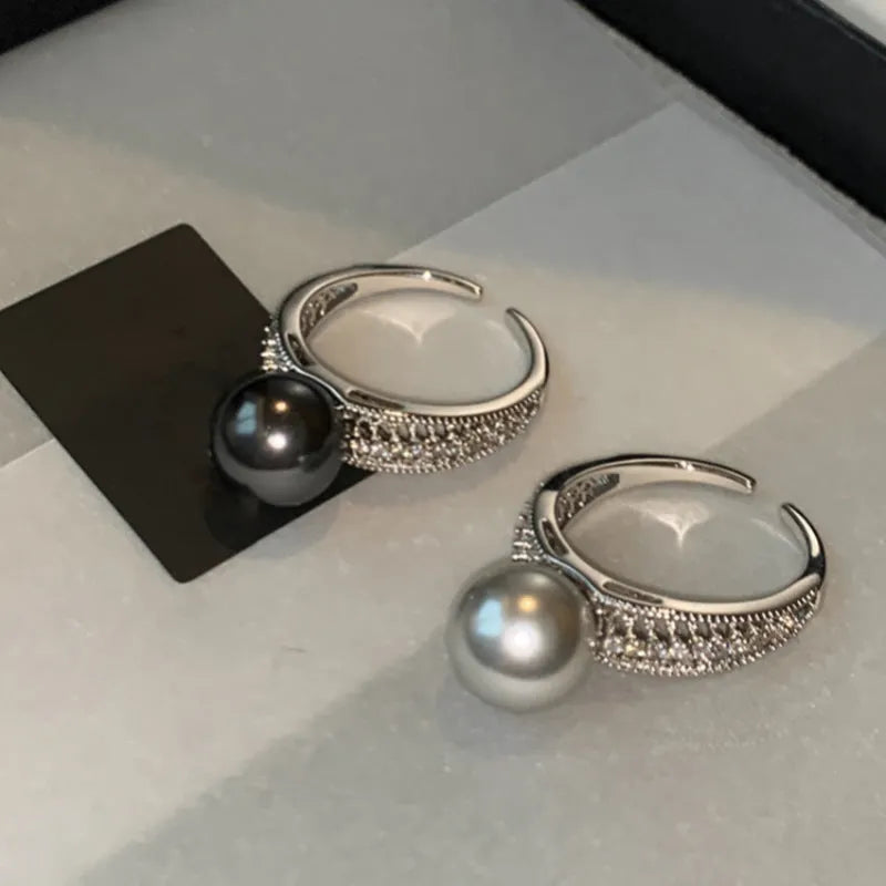 Geometric copper open band ring for women with a black pearl and adjustable opening.