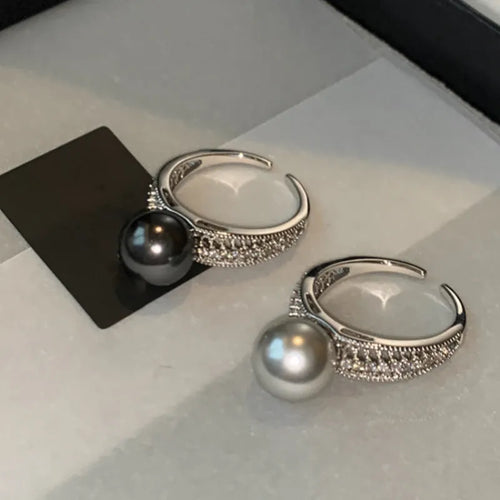 Geometric copper open band ring for women with a black pearl and adjustable opening.