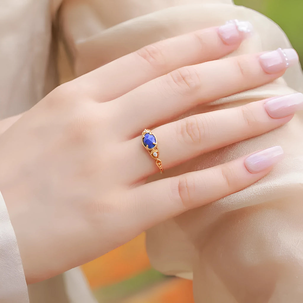 Japanese style silver alloy ring with a deep blue lapis lazuli stone in an elliptical geometric setting.