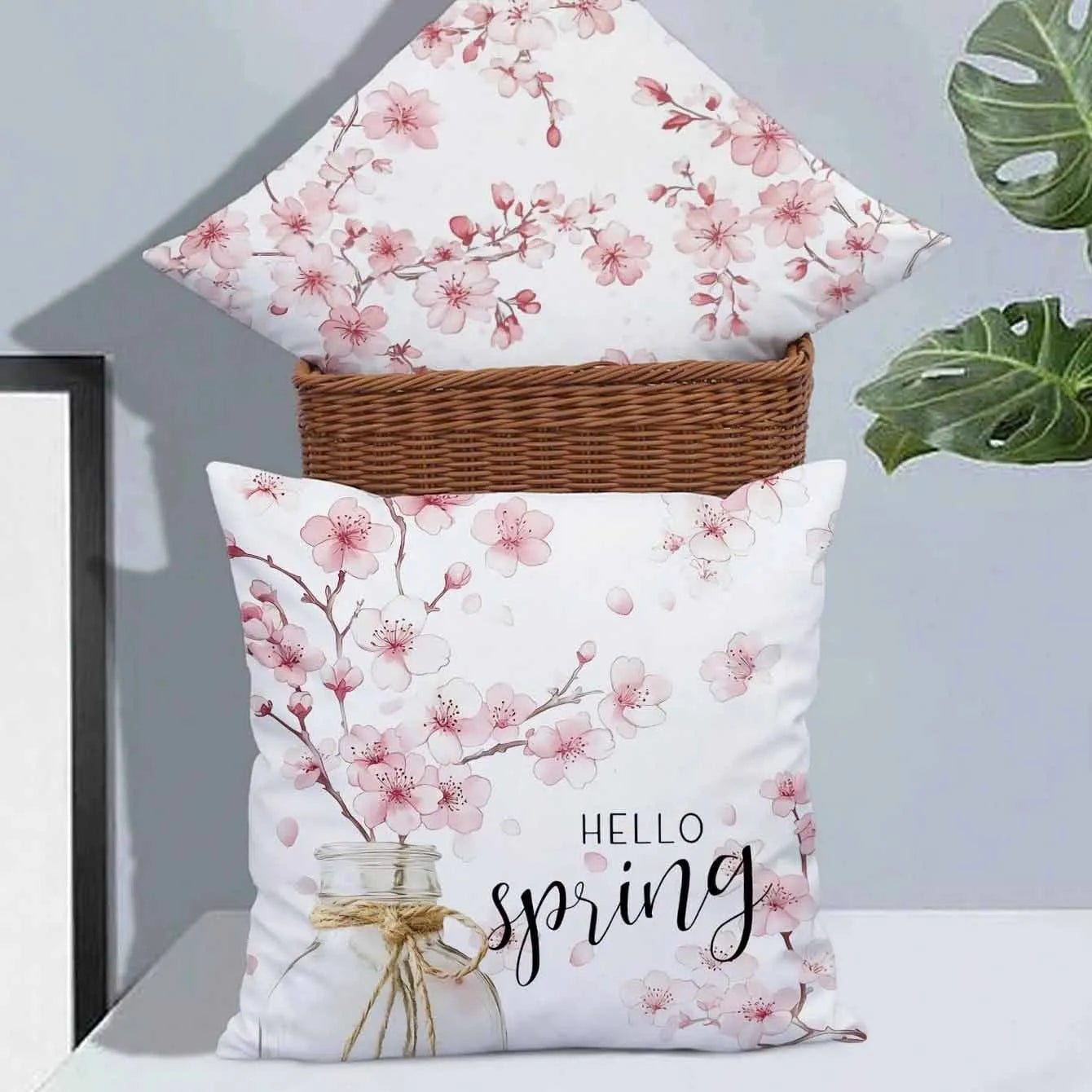 Short velvet cushion cover with cherry blossom letter print, 45cm square, shown in one of four colours.