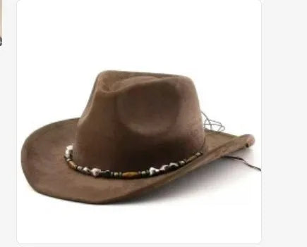 Brown leather velvet curved edge Western cowboy hat with a conical crown on a table.