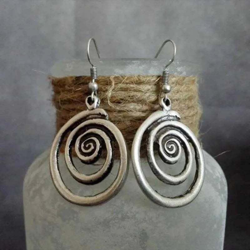 Geometric spiral distressed silver earrings measuring 2.6cm by 5cm with unisex design