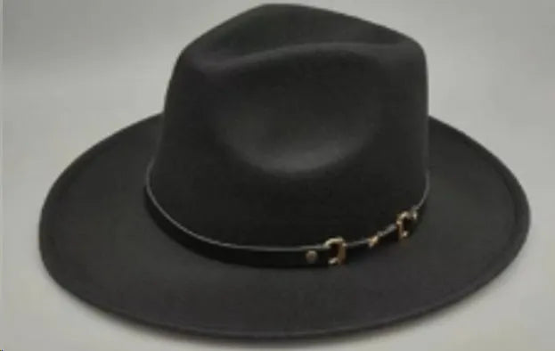 Brown leather velvet curved edge Western cowboy hat with a conical crown on a table.