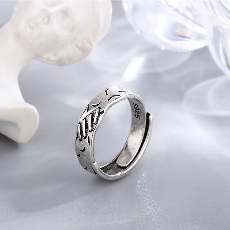 Geometric copper adjustable ring with black finish and round oval design elements