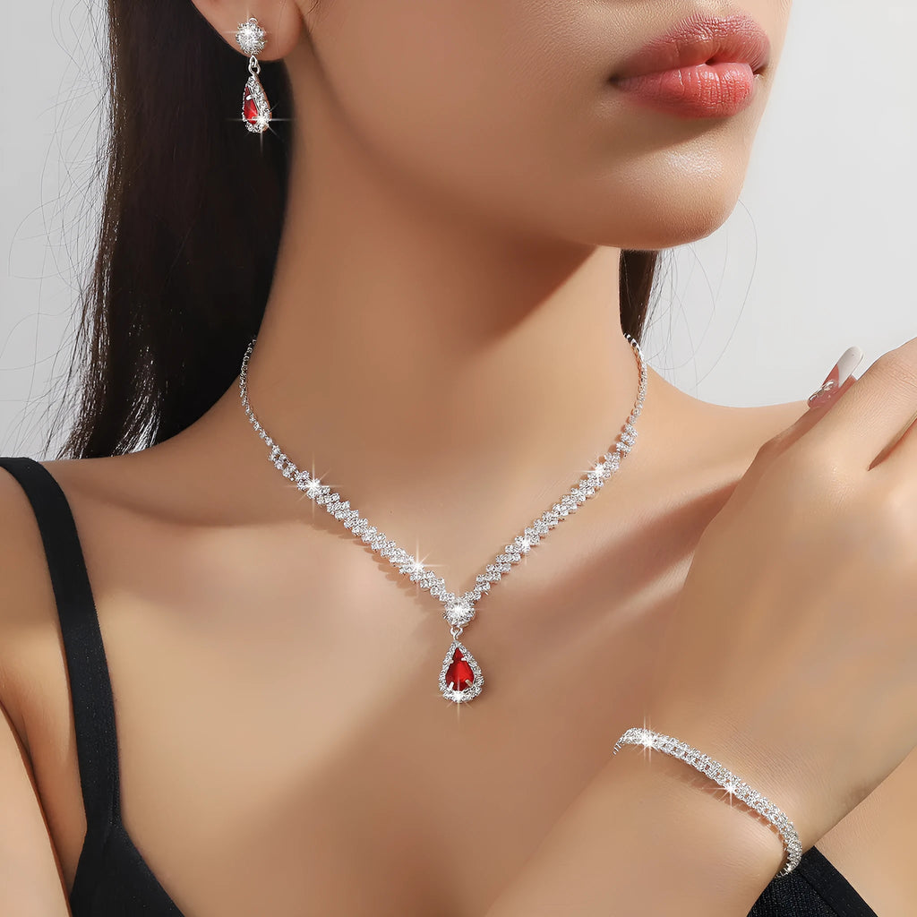 Claw chain necklace and matching earrings set with drop-shaped rhinestones in multiple colour options