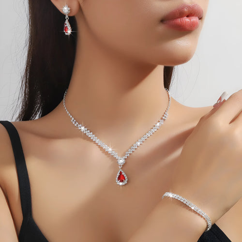 Claw chain necklace and matching earrings set with drop-shaped rhinestones in multiple colour options