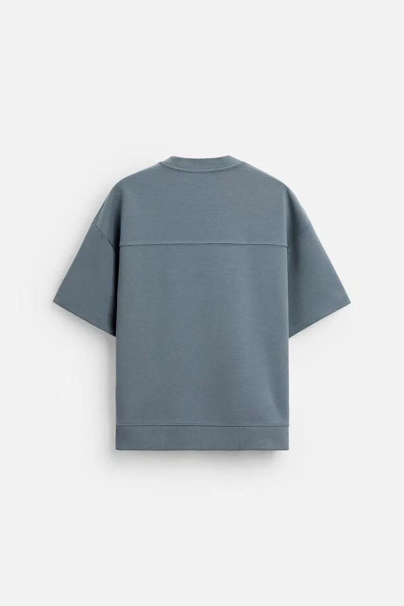 Loose blue polyester T-shirt and matching shorts set on a hanger, showing round neck and double-sided texture.