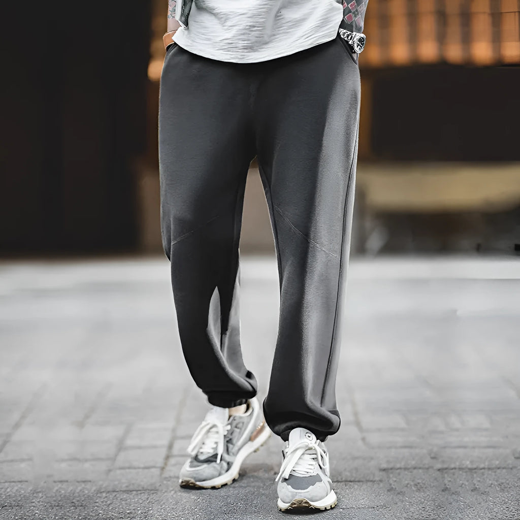 Men's cotton air layer straight-leg sweatpants in dark gray on a model