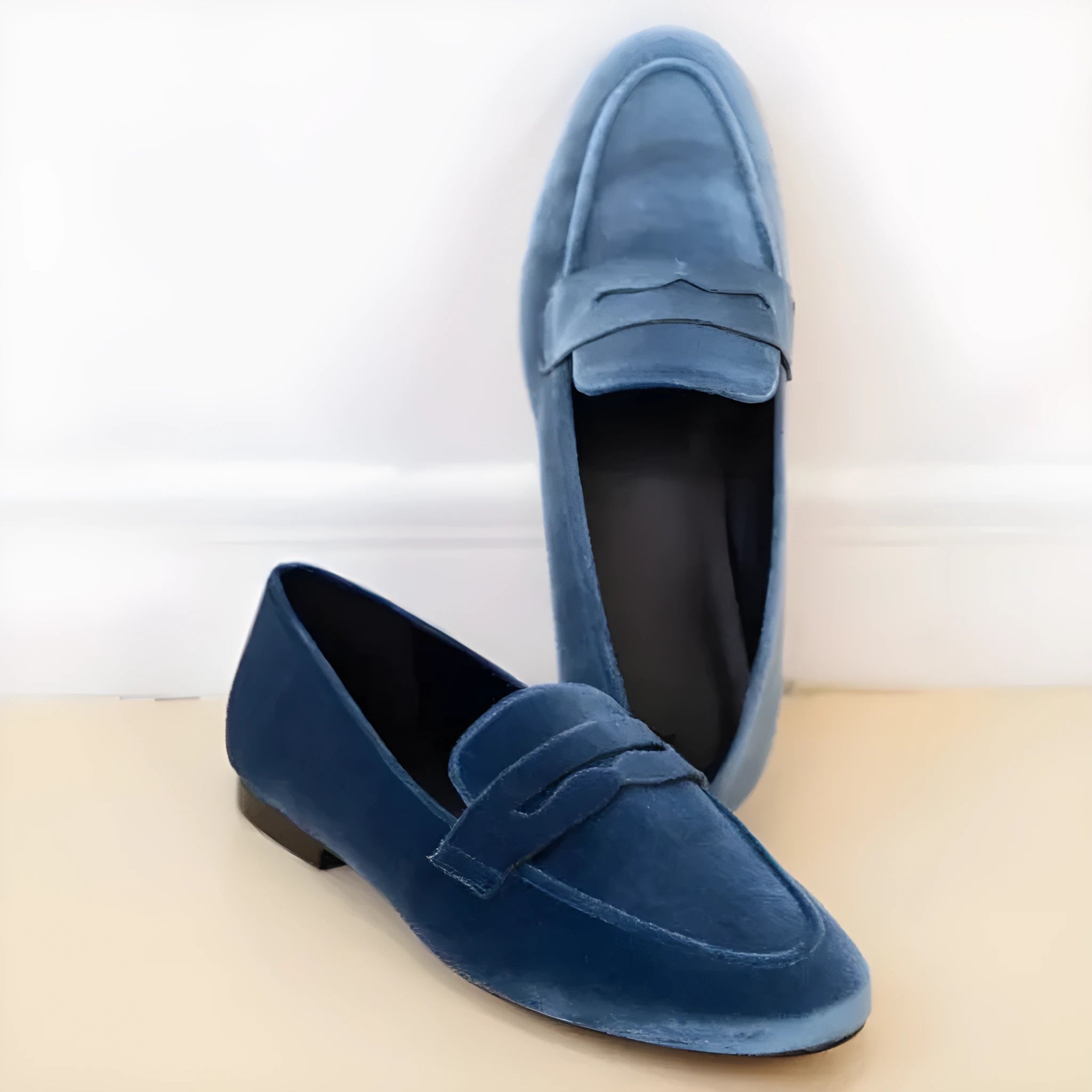Blue leisure loafers with a black rubber sole and slip-on oversleeve design.