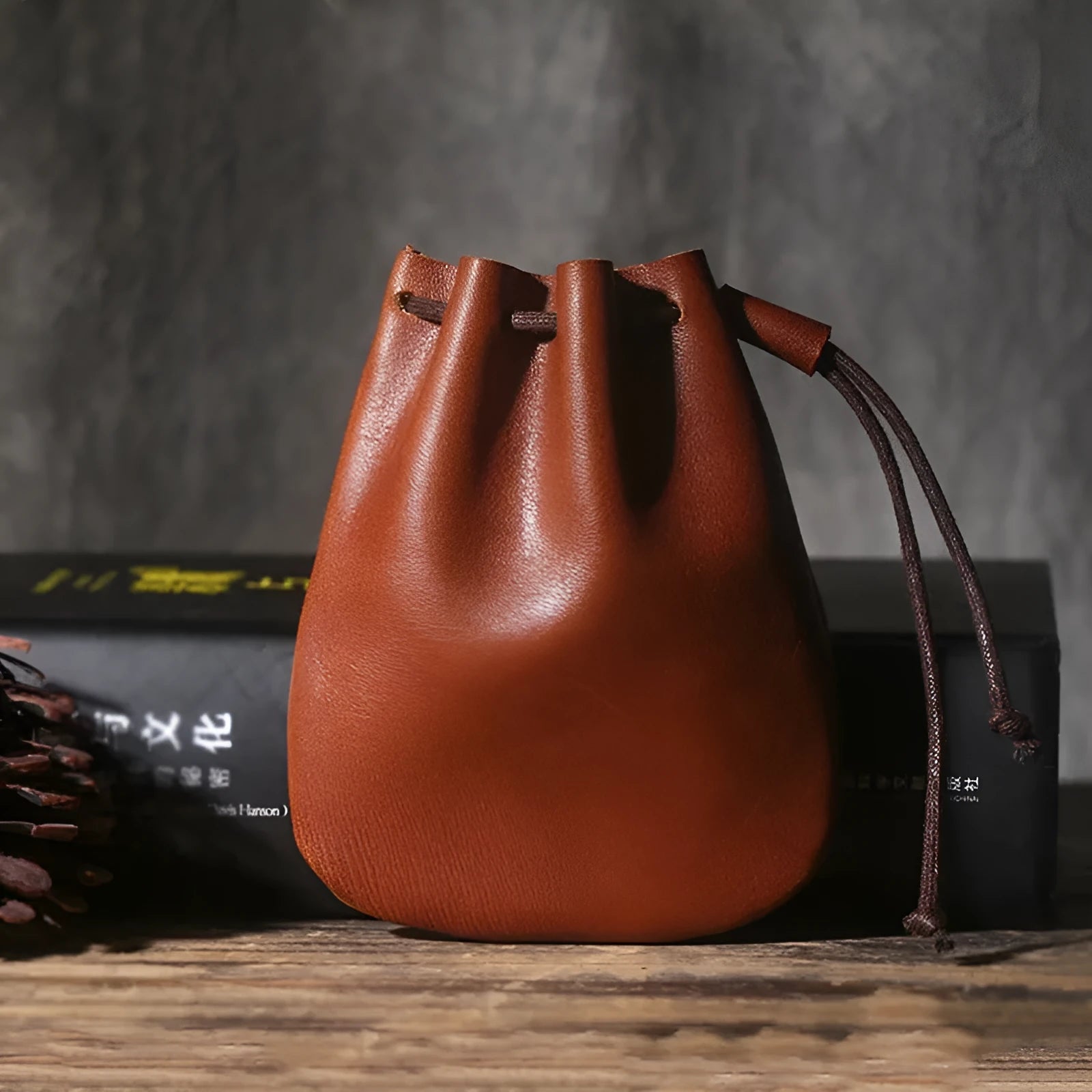 Vintage cowhide drawstring bundle wallet in chocolate brown showing sewing thread detail.