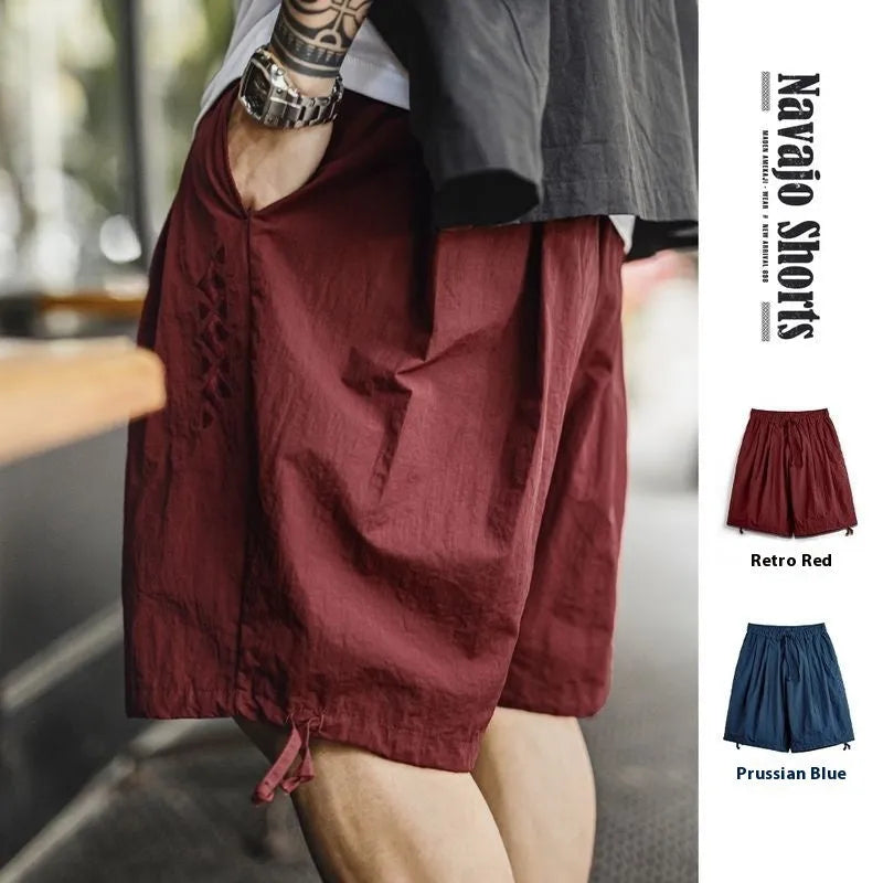 Prussian Blue men's loose fit nylon summer shorts with elastic waist and embroidered details