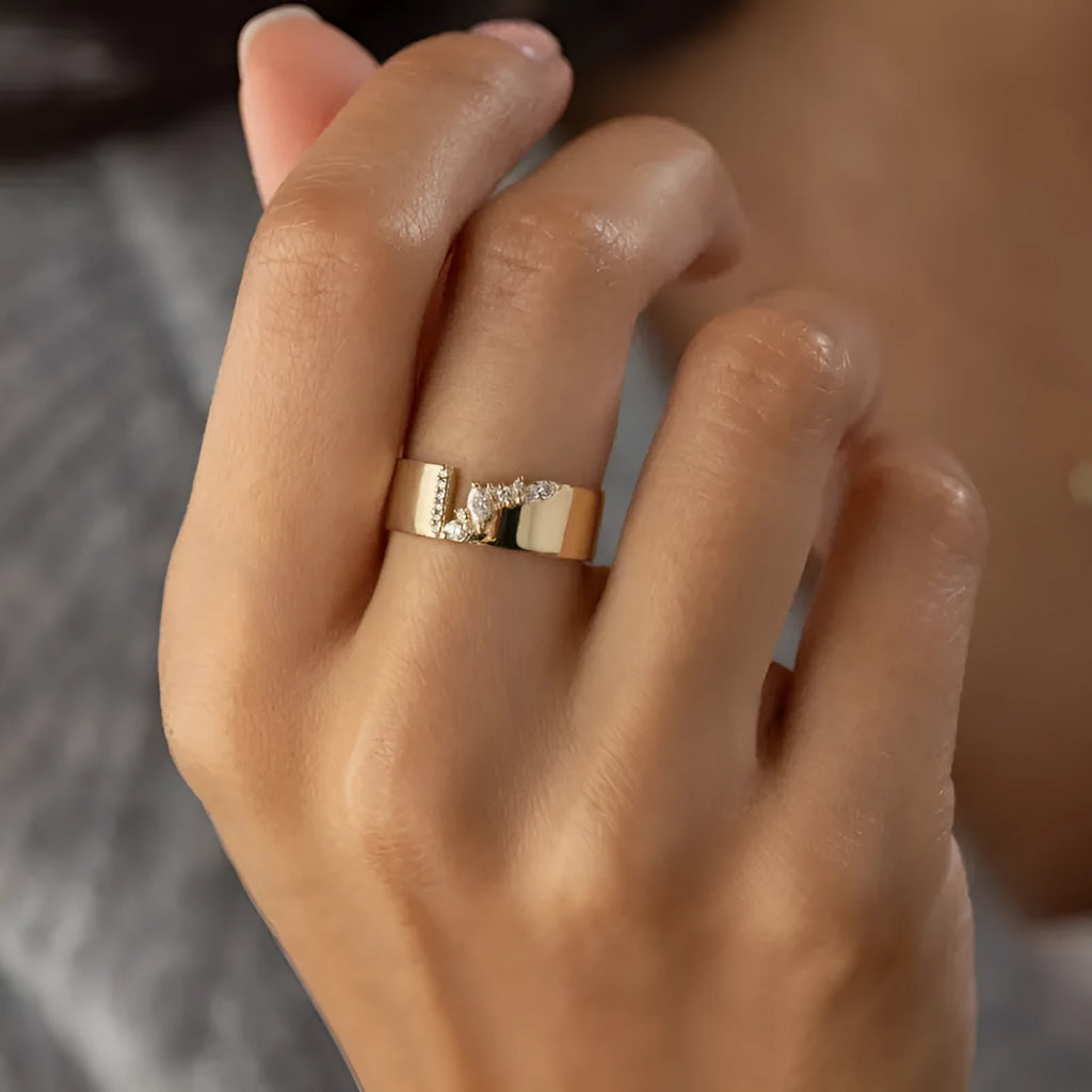 Gold-plated copper ring with shining zircon stones on a white background