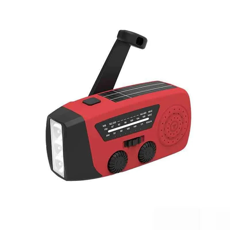 Red rechargeable hand crank emergency radio with LED torch and USB charging port.