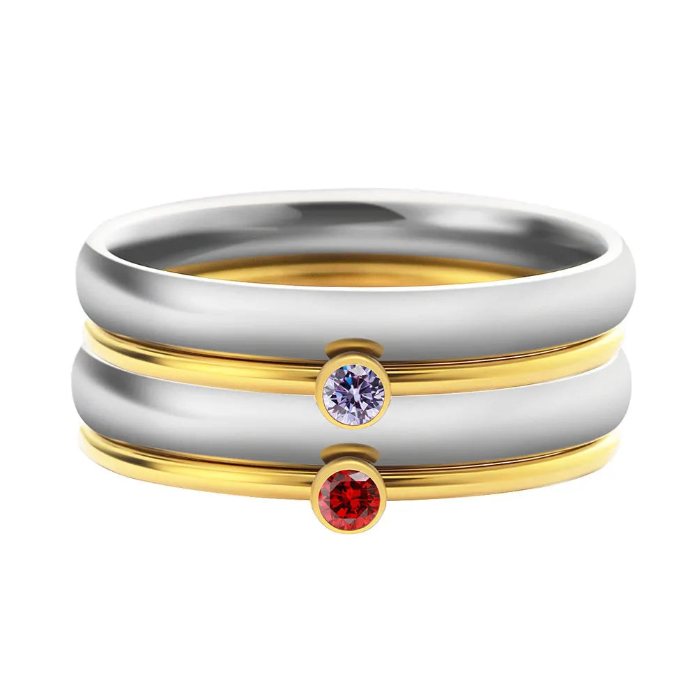 A geometric titanium steel ring featuring an engraved December birthstone design on a grey background.