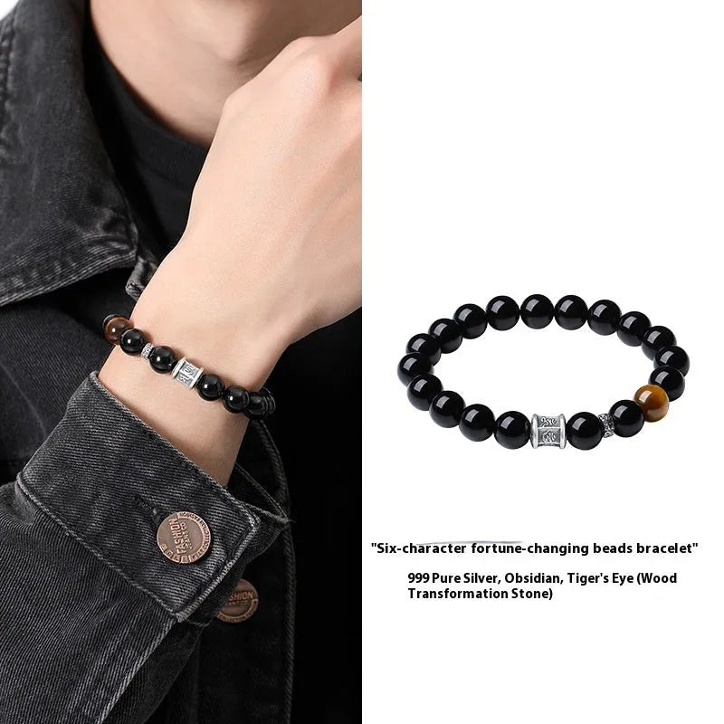 Men's obsidian prayer wheel bracelet with 10mm beads on wrist