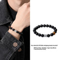 Men's obsidian prayer wheel bracelet with 10mm beads on wrist