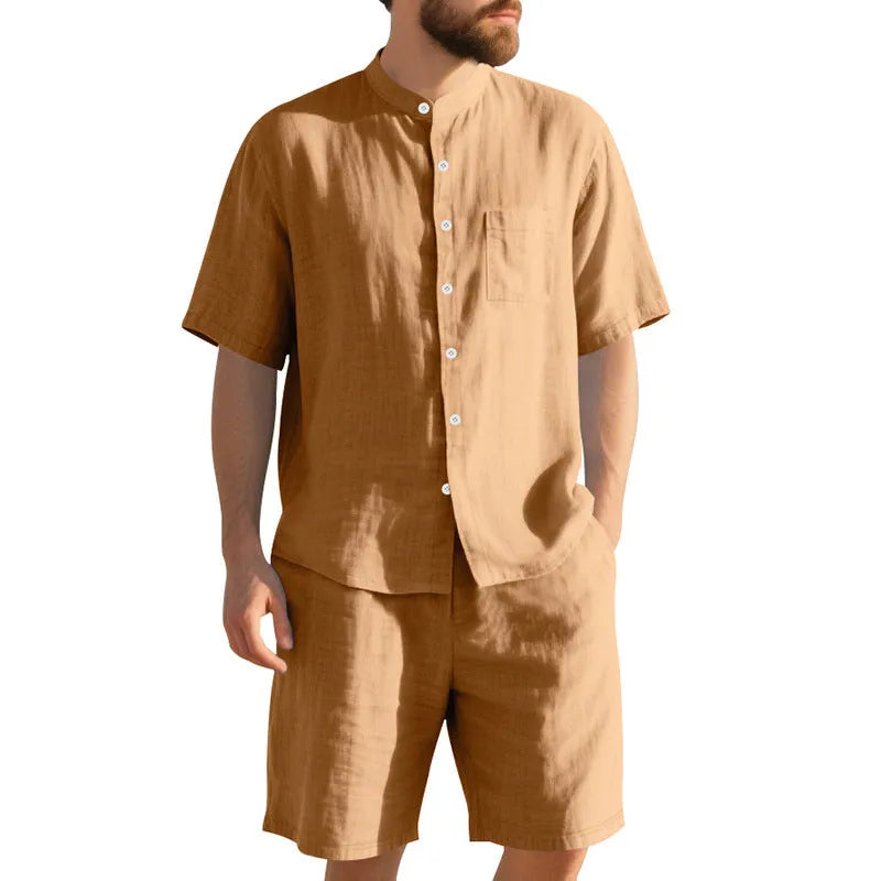 Man wearing a light blue short-sleeve linen blend suit jacket and matching shorts with a Henry collar.