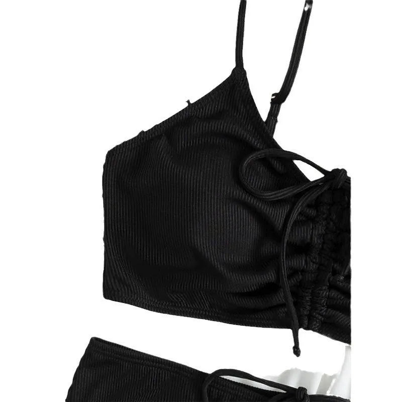 Black high-waisted bikini swimsuit for women with sleeveless top and shorts on a neutral background.