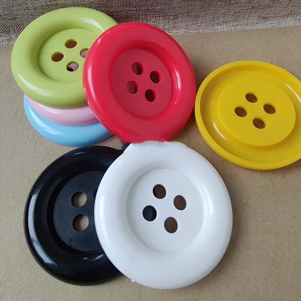 Oversized round plastic sewing buttons in multiple colours with four holes