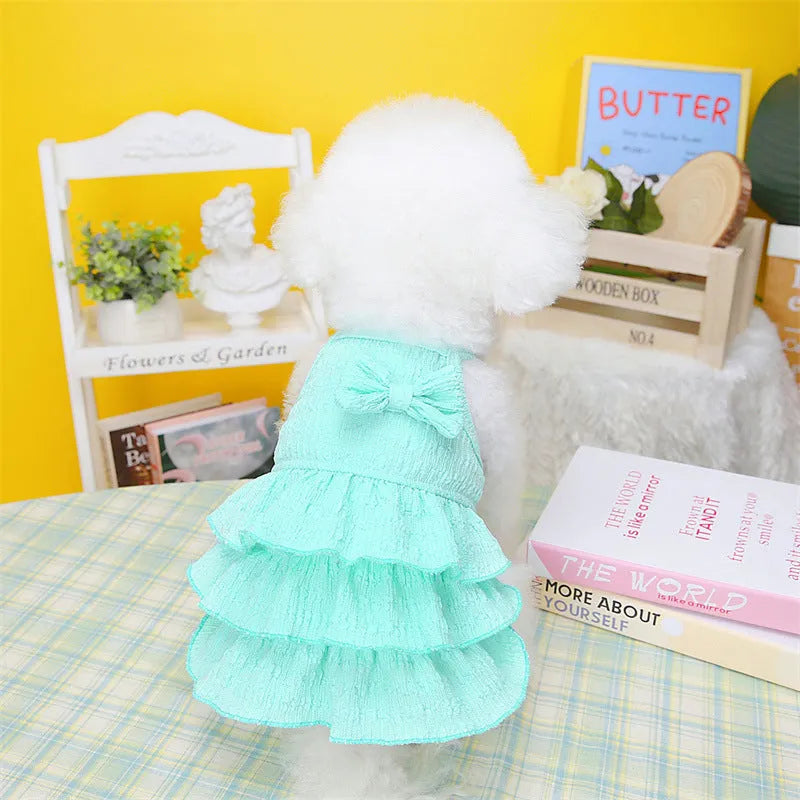 Small dog wearing candy layered skirt princess dress in rose red colour