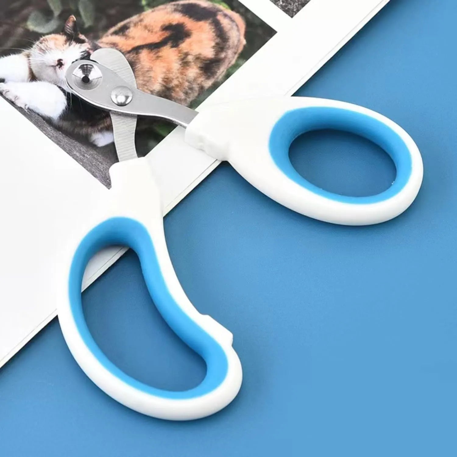 Cat nail clippers with circular hole design in blue, orange, and pink colours