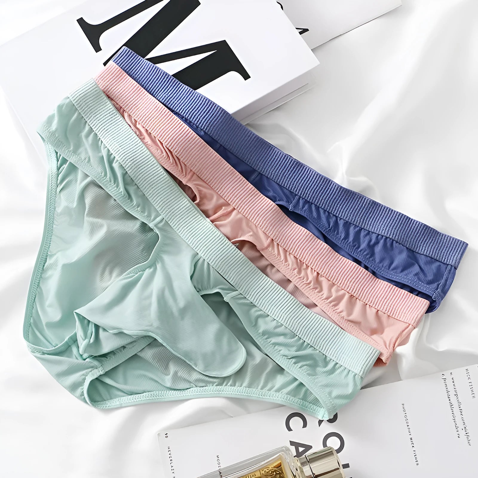 Men's ice silk low waist briefs underwear in multiple colours showing briefs style and lightweight fabric.