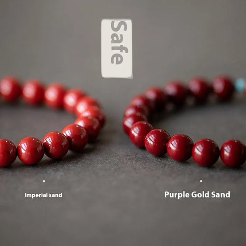 Cinnabar and coated metal geometric bracelet with elliptical beads in purple gold sand colour.