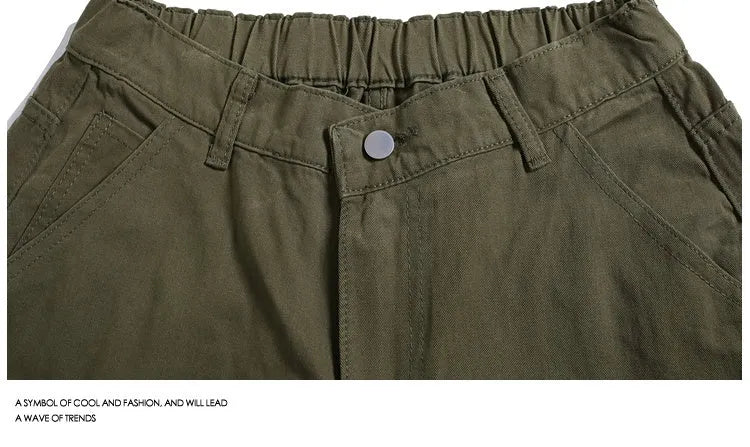 Woman wearing apricot coloured wide-leg cropped casual pants with a mid waist and elasticated band.