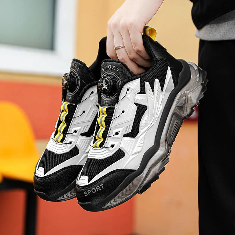 Men's black casual sneakers with a rotating button closure and low-top design.