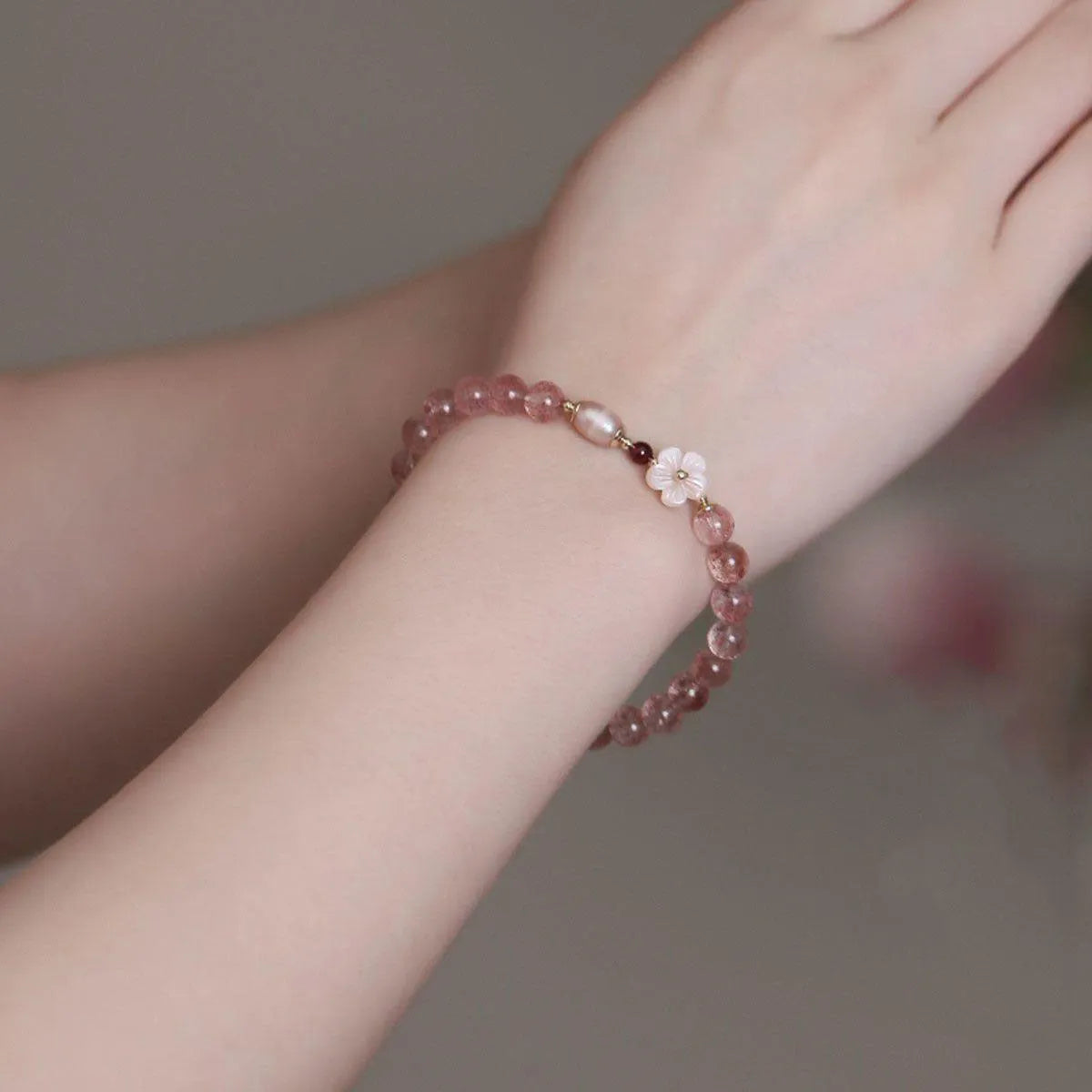 Strawberry quartz peach blossom bracelet with crystal beads and floral charm on adjustable chain