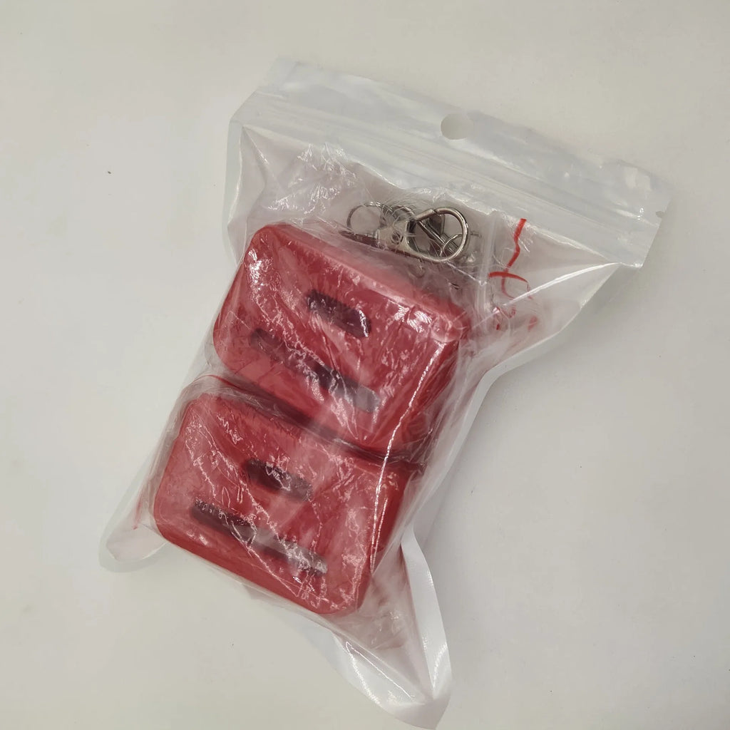 Black and red plastic seat belt buckle protective clamp holder device on a car seat.