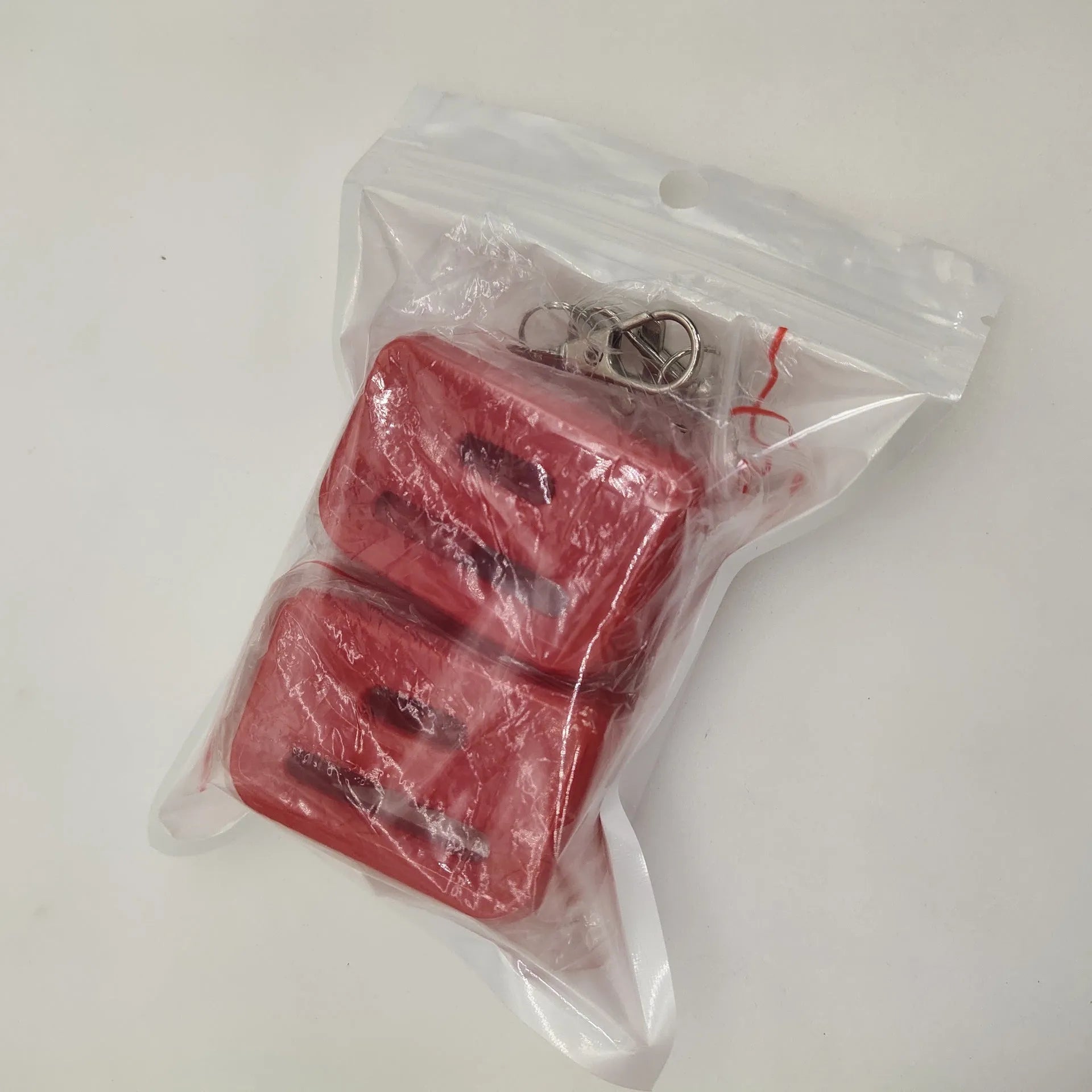 Black and red plastic seat belt buckle protective clamp holder device on a car seat.