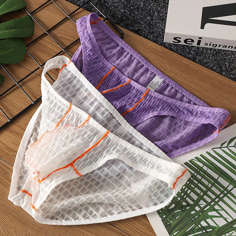 Men's low-waist lace briefs in white, black, green, red, and purple colours laid flat.