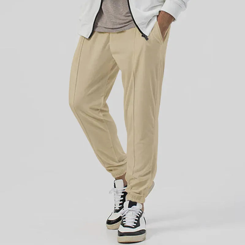 Men's grey track sweatpants with elastic waistband and straight-leg tapered fit
