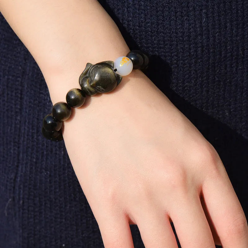 Natural obsidian stone bracelet with 10mm beads shown in gold, silver, and plain black style variations.