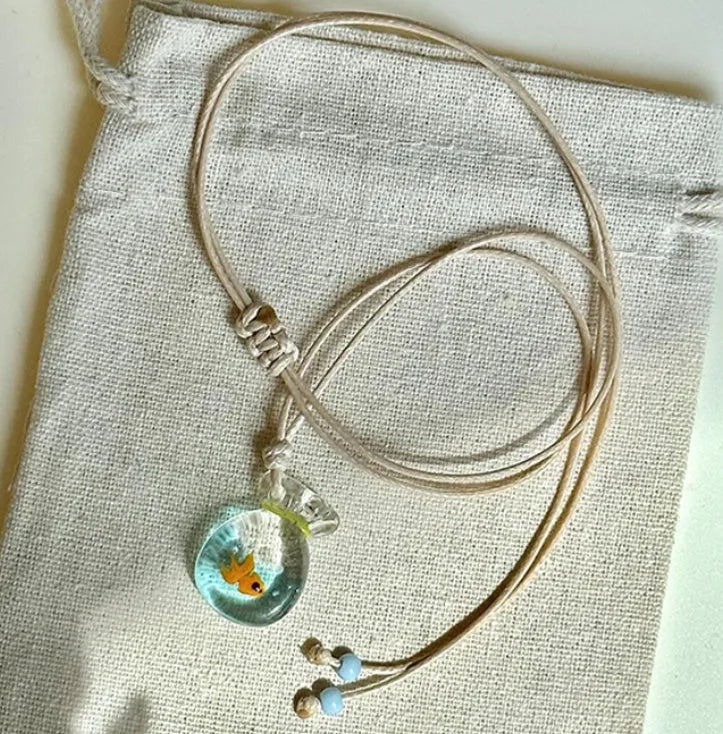 Women's necklace with coloured glaze pendant on a cotton and linen clavicle chain.