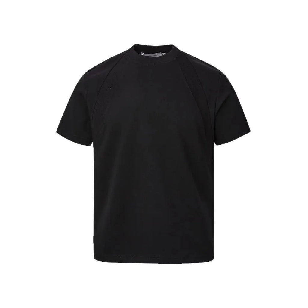 Man wearing a loose-fit grey short sleeve polyester top with air layer stitching.