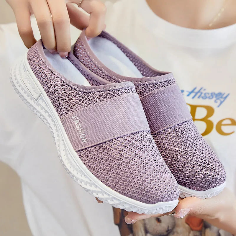 Women's casual breathable mesh shoes with hollow-out design and flat heel in black, gray, pink, or purple.