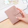Ladies short pu leather wallet with lychee pattern in beige, showing two-fold design with card slots.