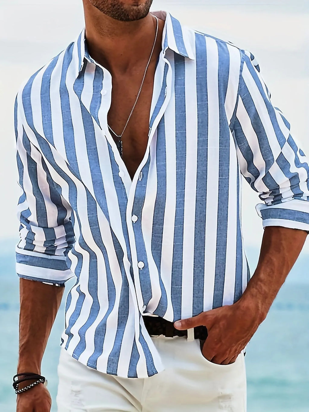 Man wearing a grey and white striped loose-fit long-sleeved casual shirt
